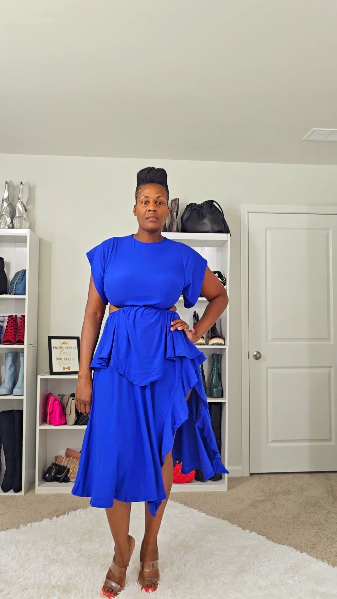 Woman wearing a ruffled midi A-line dress with crew neckline, flutter short sleeves, side cut outs, side slit, and layered ruffle hem, perfect for casual chic style