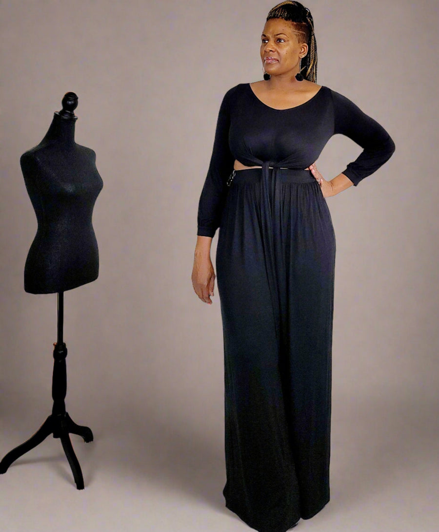 Black Palazzo Pants 2PC Set from Tosh`E Boutique, featuring a stylish crop top with a round neckline, long sleeves, and a self-tie detail at the waist. The wide-leg palazzo pants include an elastic waistband and practical pockets. Made from a soft and stretchy blend of 95% Rayon and 5% Spandex, this set combines elegance and comfort for versatile, day-to-night wear.