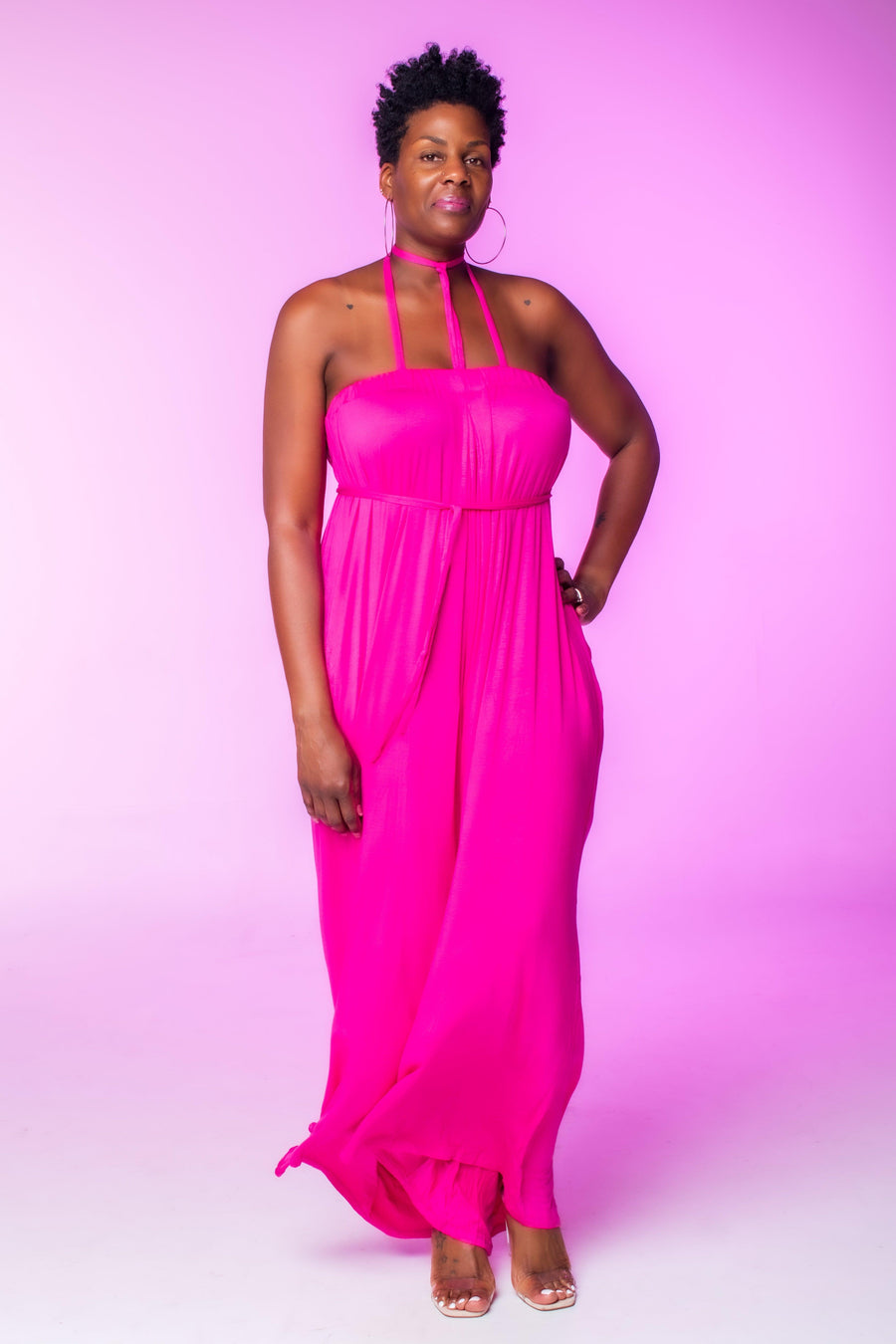 Fuchsia Wide Leg Jumpsuit  Introducing our Fuchsia Wide Leg Jumpsuit, crafted from stretch material to ensure a comfortable fit that runs slightly large. This sleeveless jumpsuit features wide legs and practical pockets, offering both style and functionality. The vibrant fuchsia hue adds a bold and stylish statement to your wardrobe, perfect for making a standout impression.  Key Features:  Fuchsia Color: Vibrant and eye-catching.