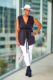 Black Sleeveless Vest with Belt  Introducing our 100% polyester sleeveless vest in black, complete with an included belt. This vest features a stylish and timeless design, perfect for any smart casual occasion, whether for work or after-work apparel. Its versatility is unmatched, offering effortless style and sophistication.  Key Features:  Material: Crafted from 100% polyester for durability and comfort. Sleeveless Design: Provides freedom of movement and a sleek silhouette.