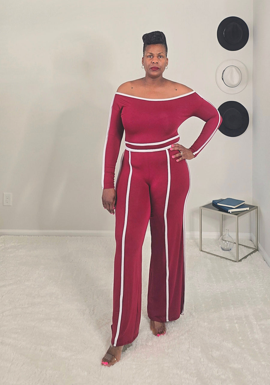 Woman wearing a burgundy and white outfit with a plain background