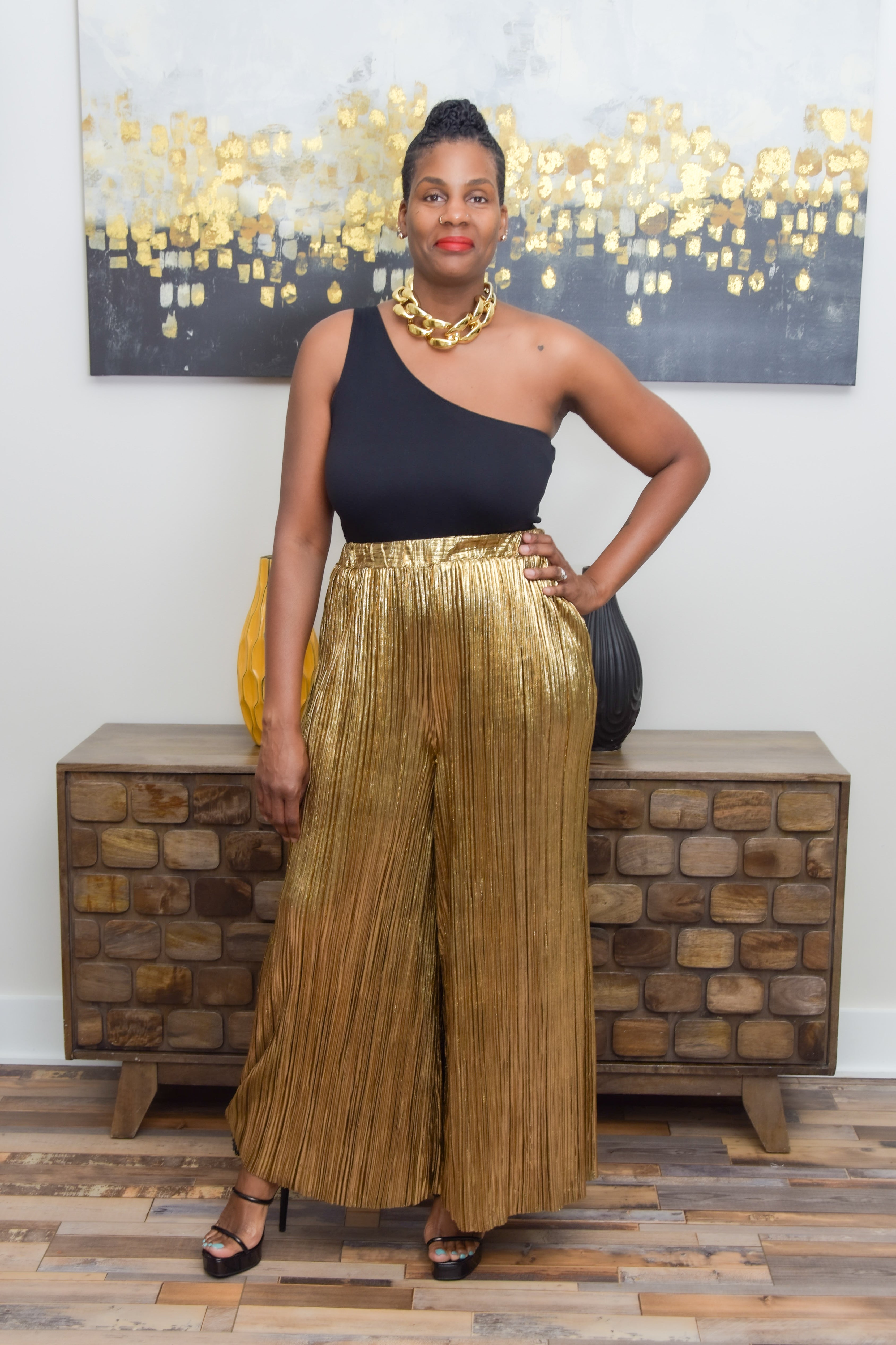 Introducing our Metallic Gold High Cinched Waist Wide Leg Pants—a dazzling addition to your wardrobe that effortlessly blends glamour with comfort. The metallic gold hue exudes opulence, catching the light with every step and ensuring you stand out in any crowd.  