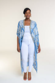 Available in Denim Damask Print  Elevate your style with our beautifully crafted top, available in a stunning denim damask print. This versatile piece is perfect for any occasion, blending elegance with casual charm.  Key Features:  Split Angel Sleeves: Add a touch of sophistication and flowy elegance with our unique split angel sleeves. Mini Pom Pom Accent: Delicate mini pom pom accents along the edges provide a playful yet chic detail. 100% Viscose: