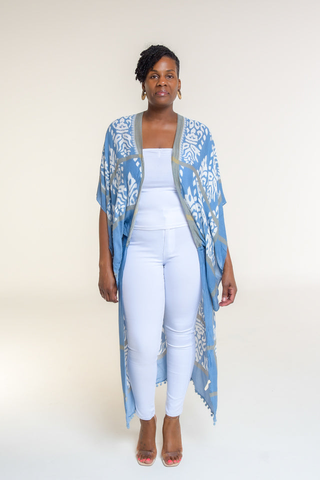 Available in Denim Damask Print  Elevate your style with our beautifully crafted top, available in a stunning denim damask print. This versatile piece is perfect for any occasion, blending elegance with casual charm.  Key Features:  Split Angel Sleeves: Add a touch of sophistication and flowy elegance with our unique split angel sleeves. Mini Pom Pom Accent: Delicate mini pom pom accents along the edges provide a playful yet chic detail. 100% Viscose: