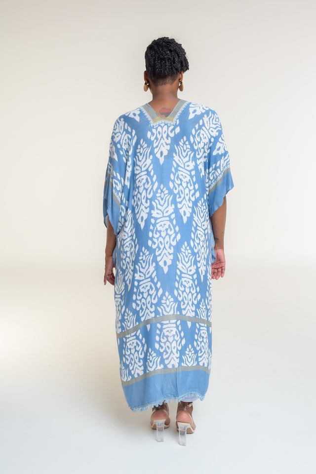 Available in Denim Damask Print  Elevate your style with our beautifully crafted top, available in a stunning denim damask print. This versatile piece is perfect for any occasion, blending elegance with casual charm.  Key Features:  Split Angel Sleeves: Add a touch of sophistication and flowy elegance with our unique split angel sleeves. Mini Pom Pom Accent: Delicate mini pom pom accents along the edges provide a playful yet chic detail. 100% Viscose: 