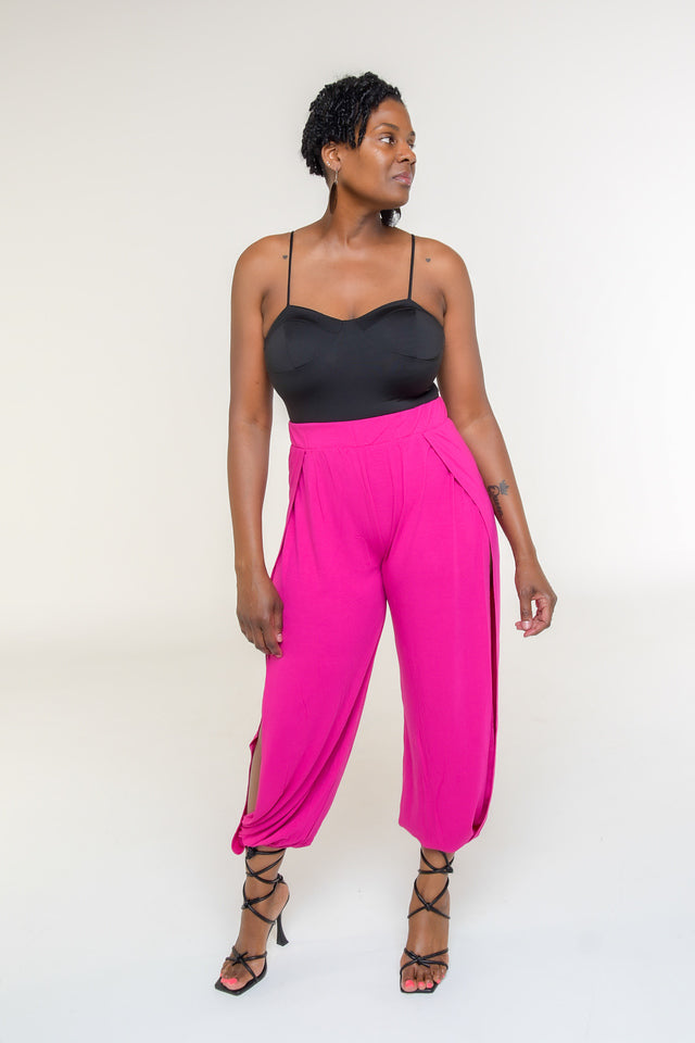 Magenta Split-Side Harem Pants: Stylish Comfort and Flexibility  Elevate your casual style with our Magenta Split-Side Harem Pants, designed to combine chic aesthetics with ultimate comfort. The split sides add a trendy flair, while the elastic waist ensures a perfect fit and excellent stretch. Crafted from a soft and breathable blend of polyester, rayon, and spandex, these harem pants offer both style and flexibility. Pair them with sandals or sneakers for a laid-back look.  