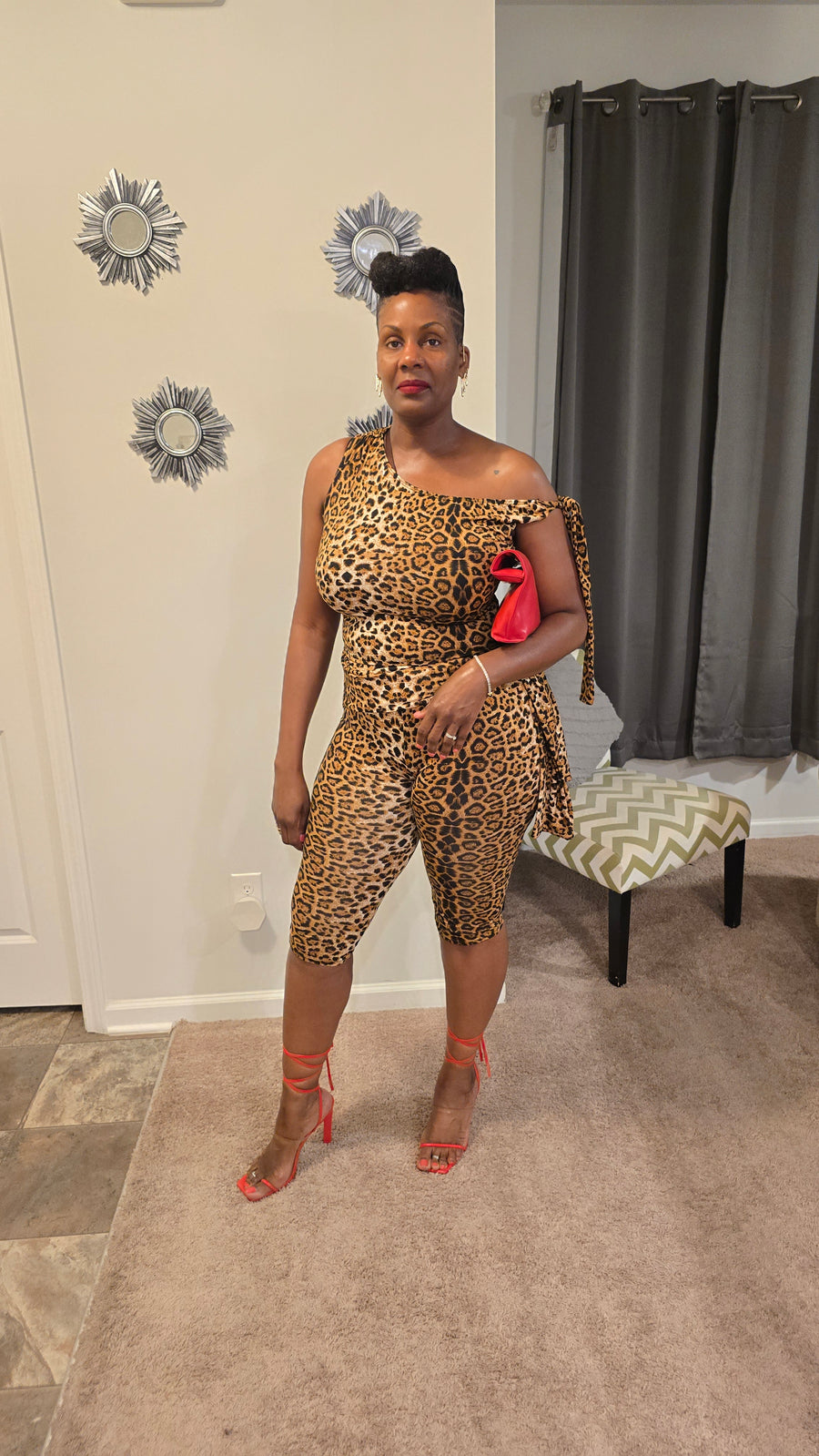 Women's leopard print two-piece set featuring an asymmetrical one-shoulder top with tie detail and matching high-waisted capri pants. Bold, stretchy, and figure-flattering—perfect for a confident, fashion-forward look.