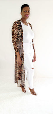 Long Leopard Kimono  Step out and make a statement in our long leopard kimono. Featuring a bold and daring leopard print, floor-length silhouette, tie waist, and long sleeves, this open-front kimono exudes timeless style and sophistication. Dare to be different and showcase your adventurous spirit with this standout piece.  Key Features:  Leopard Print: Bold and daring, the leopard print adds a touch of wild elegance to your wardrobe. Floor-Length Silhouette: 