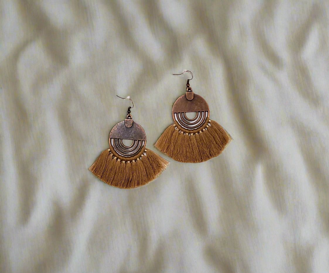 Stylish Brown Tassel Drop Earrings designed to make a bold statement and add a playful touch to any outfit. Featuring long, dynamic tassels in a rich brown color, these earrings are lightweight and comfortable for all-day wear. Perfect for expressing individuality and adding a fun, sassy flair to your look."