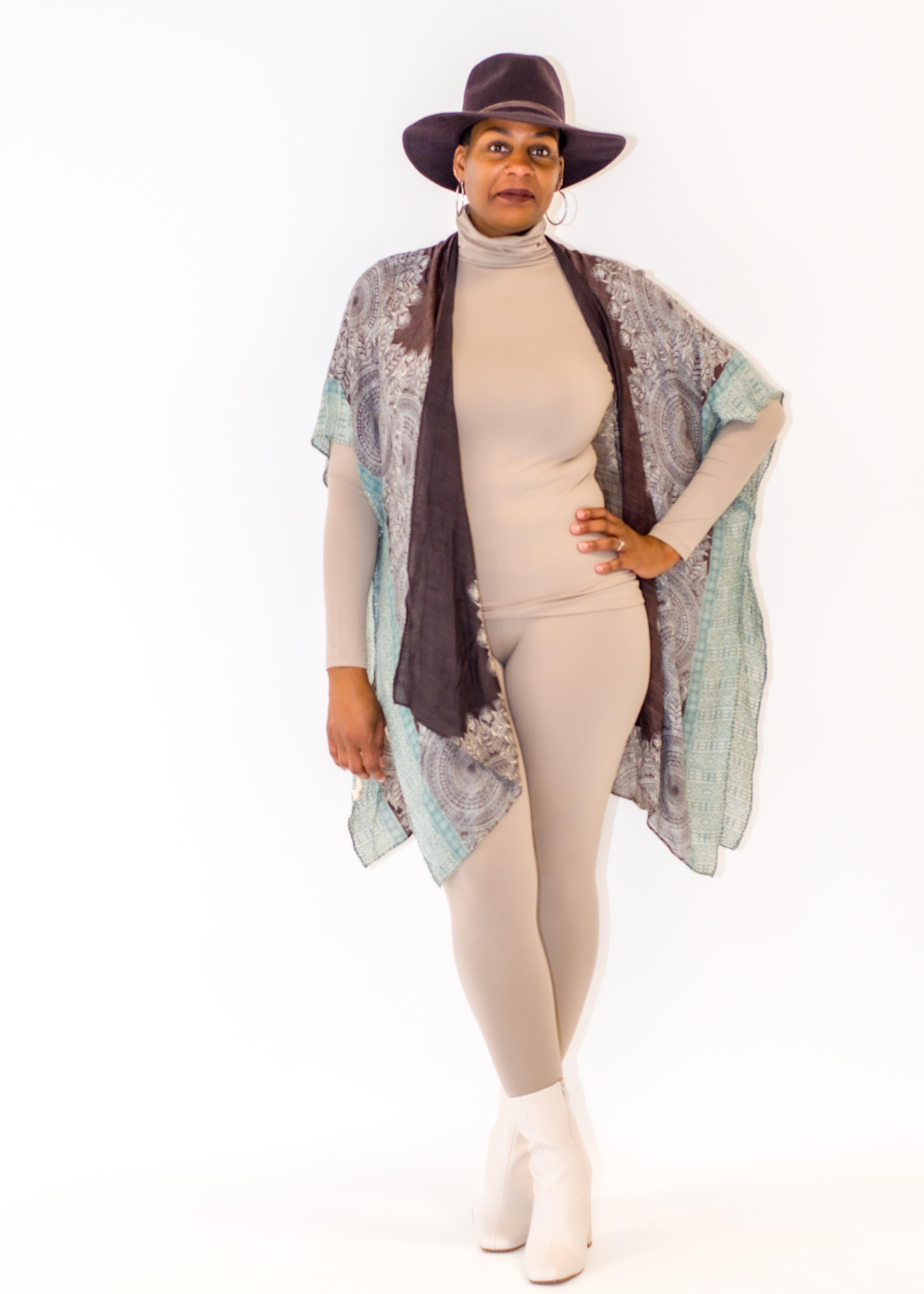 Mandala Print Kimono  Refresh your wardrobe with our exquisite Mandala Print Kimono, crafted from 100% viscose to create a luxurious and lightweight silhouette. This kimono features a bold Mandala pattern that will effortlessly draw attention wherever you go. A timeless accessory, perfect for any special occasion.  Key Features:  Material: Made from 100% viscose for a soft, breathable, and luxurious feel. Bold Mandala Print: Adds a vibrant and eye-catching element to your outfit. Versatile Silhouette: 