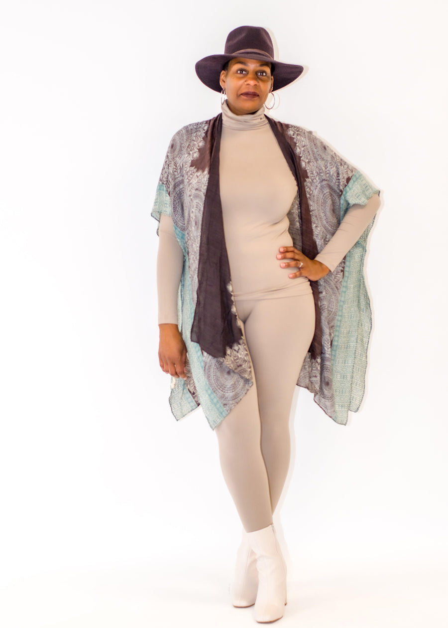 Mandala Print Kimono  Refresh your wardrobe with our exquisite Mandala Print Kimono, crafted from 100% viscose to create a luxurious and lightweight silhouette. This kimono features a bold Mandala pattern that will effortlessly draw attention wherever you go. A timeless accessory, perfect for any special occasion.  Key Features:  Material: Made from 100% viscose for a soft, breathable, and luxurious feel. Bold Mandala Print: Adds a vibrant and eye-catching element to your outfit. Versatile Silhouette: 
