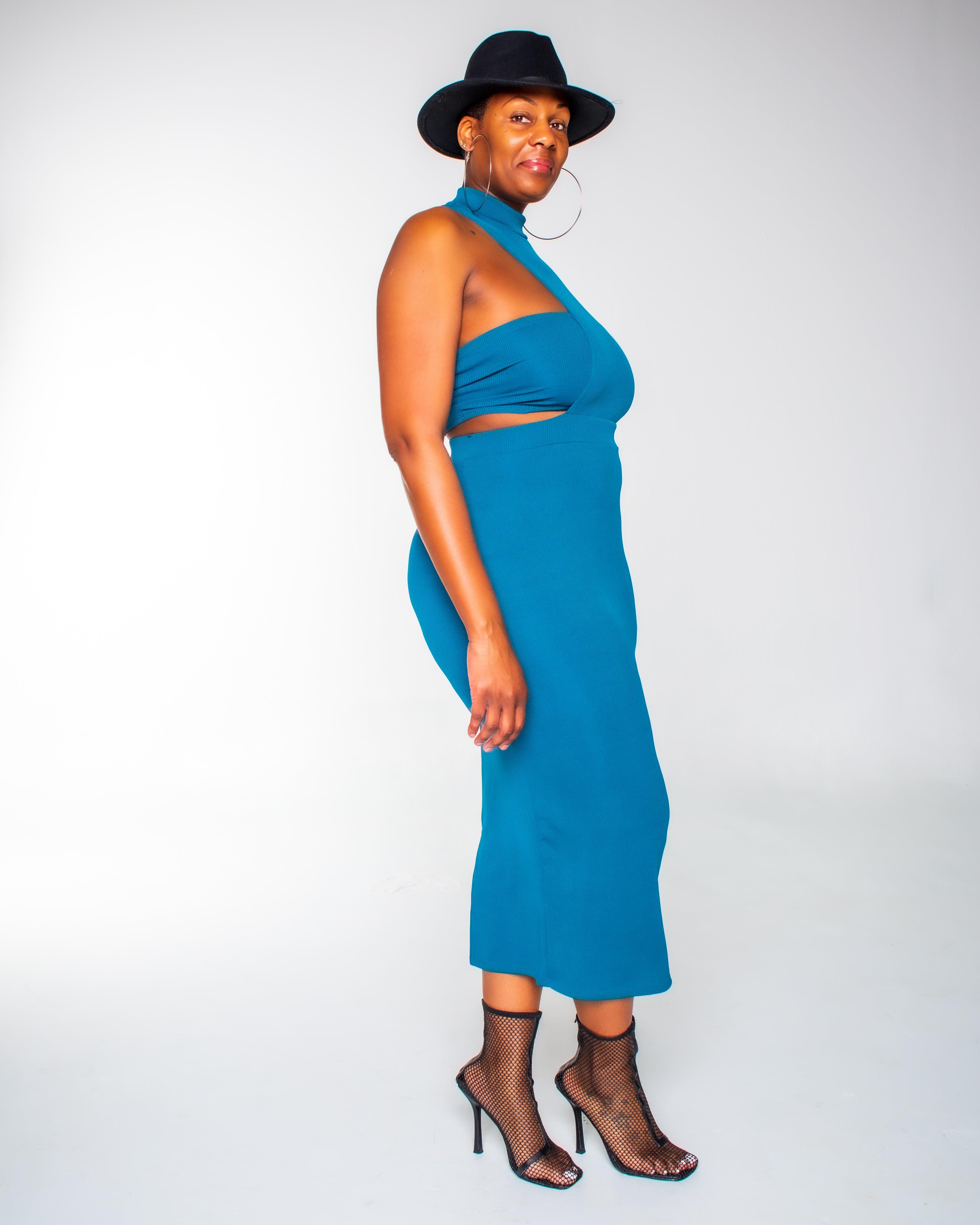 Effortless Style: Teal Two Piece Set  Available in Teal, this Two Piece Set is designed to make a statement. The set features a stretchy dress with a chic cutout detail and ribbed texture, complemented by a matching tube top. The dress boasts a round neckline and long sleeves, providing a balance of comfort and style. Made from a blend of 64% polyester, 33% rayon, and 3% spandex, this outfit offers a soft, flexible fit that's perfect for any occasion. 