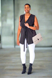 Black Sleeveless Vest with Belt  Introducing our 100% polyester sleeveless vest in black, complete with an included belt. This vest features a stylish and timeless design, perfect for any smart casual occasion, whether for work or after-work apparel. Its versatility is unmatched, offering effortless style and sophistication.  Key Features:  Material: Crafted from 100% polyester for durability and comfort. Sleeveless Design: Provides freedom of movement and a sleek silhouette. 