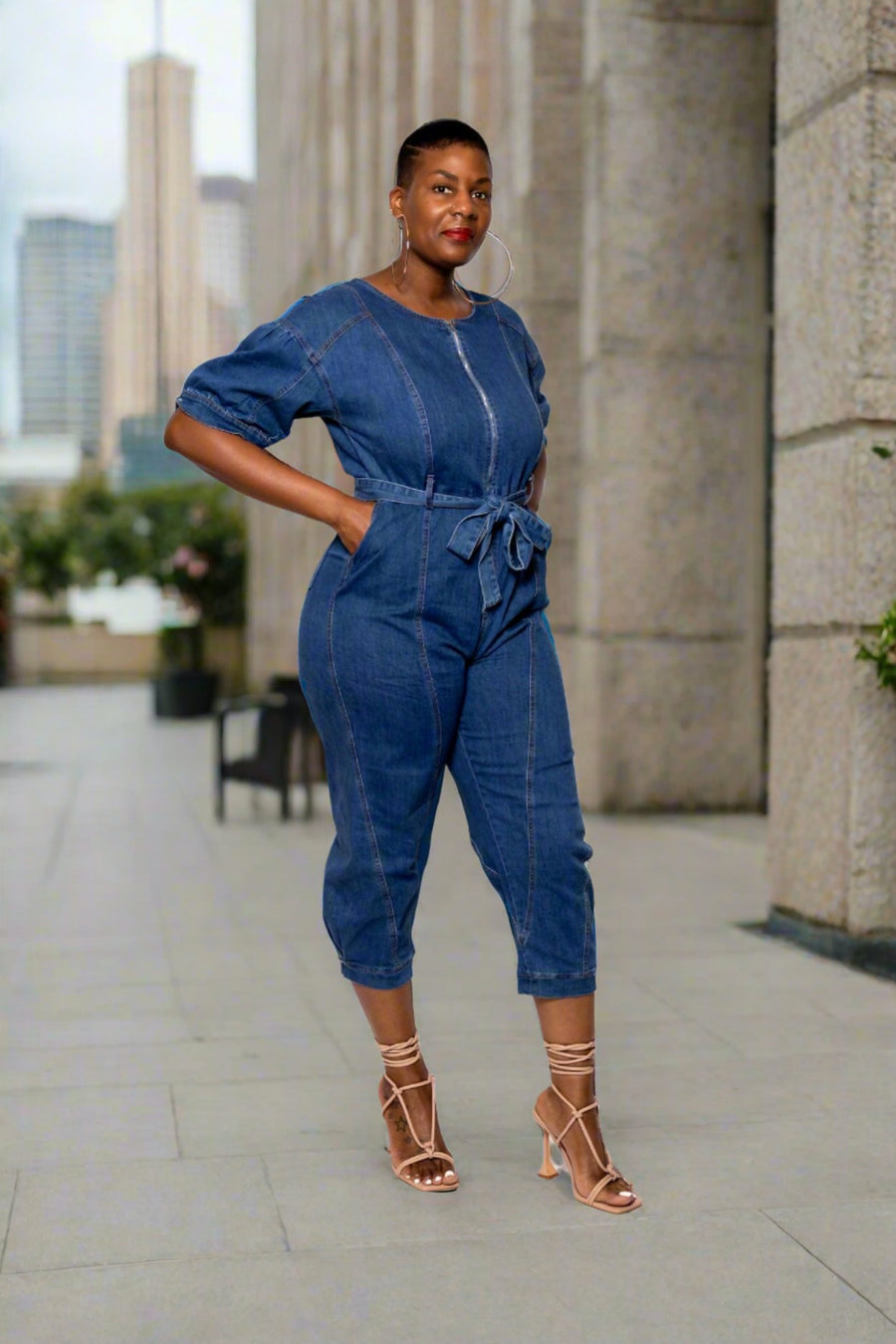 Peplum Sleeve Denim Jumpsuit  Experience effortless style and comfort with the Peplum Sleeve Denim Jumpsuit! Crafted with 75% cotton, 23% polyester, and 2% spandex, this lightweight jumpsuit is soft and breathable - perfect for long days. Structure and shape are maintained through the semi-stretch material, while the peplum sleeve and included belt add a stylish and unique flair. Put the finishing touches on your look with the pockets to store your essentials