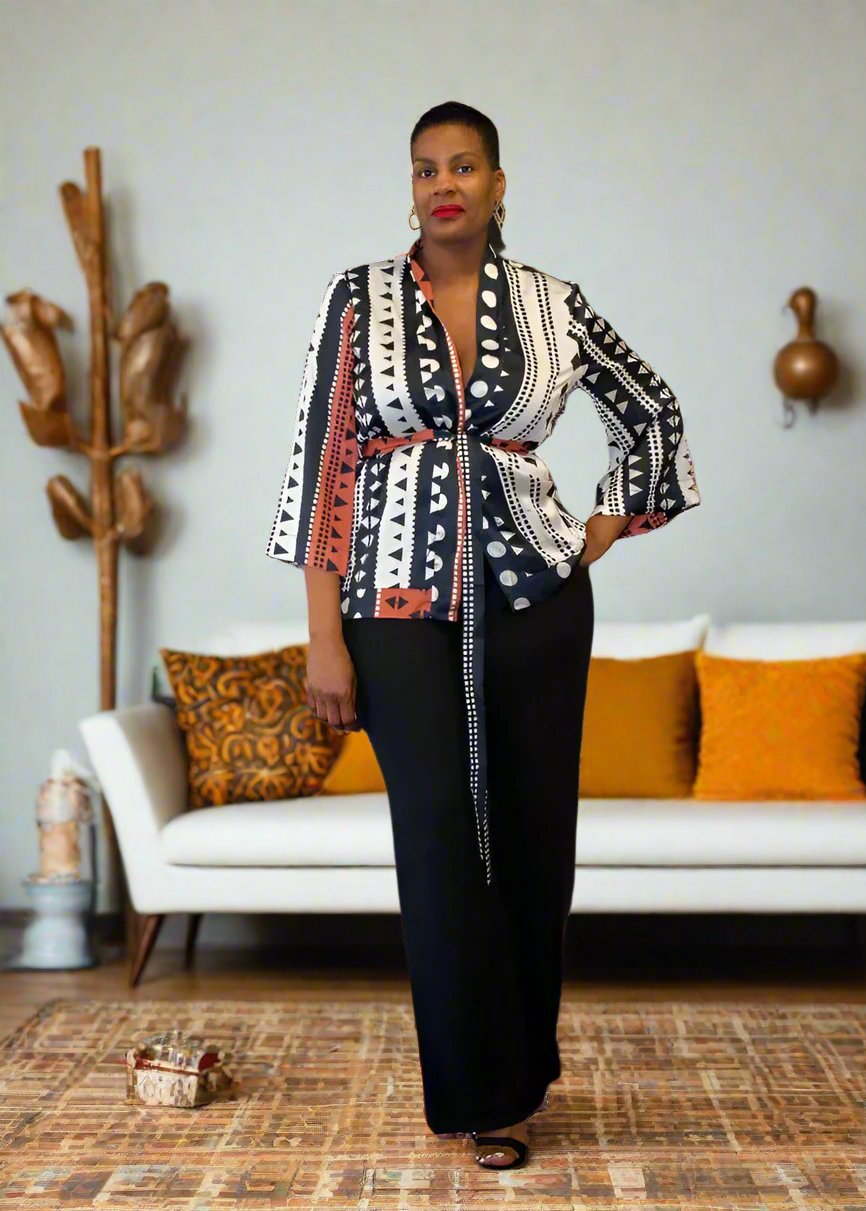 Luxurious Multi Print Kimono Set from Tosh`E Boutique, featuring a flowing open-front kimono top and high-waisted wide-leg satin pants. Crafted from a premium blend of satin and spandex, this two-piece ensemble includes practical pockets and a contemporary black belt to accentuate the waist. Ideal for special events or adding elegance to your everyday style.