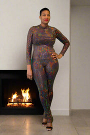 Achieve radiant glamour with our Two-Piece Gold Sequin Set. This stunning ensemble features a mock neck, long sleeve top, and mesmerizing slit leggings that are designed to captivate and dazzle. The luxurious gold sequins cover each piece, reflecting light with every movement, ensuring you shine brightly wherever you go.  